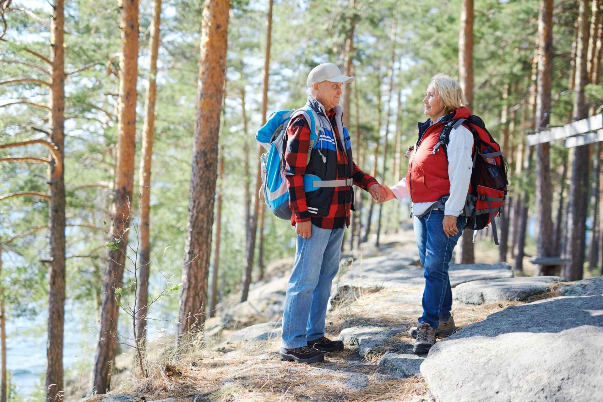 Two seniors enjoying a beautiful outdoor hike.